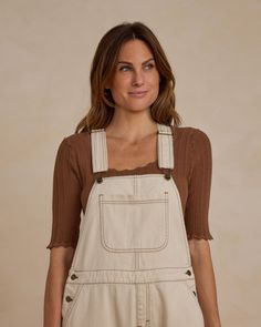 Our utility overalls have adjustable straps with metal buttons, an open bib pocket, and metal buttons at the sides. It also has back pockets! Color: Natural Care: Machine wash cold. Tumble dry low. Made of 100% Cotton Utility Overalls, Natural Care, Suit Shop, Knot Headband, Sweater Coats, Dress Romper, Metal Buttons, Bow Headband, Apparel Accessories