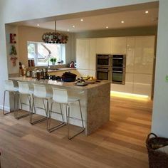 a kitchen with an island and bar stools