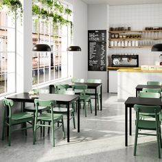 an empty restaurant with green chairs and tables