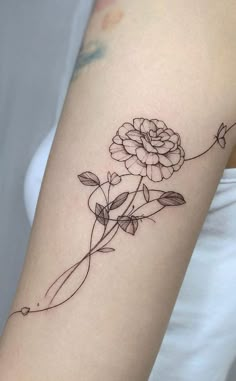 a rose tattoo on the arm