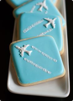 cookies decorated with blue icing are on a plate