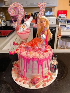 a barbie doll cake with pink icing and sprinkles