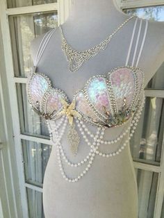 a mannequin wearing a bra with pearls on it