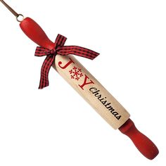 a christmas cracker ornament with a red ribbon and the word joy on it