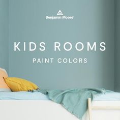 a child's room with blue walls and yellow pillows on top of the bed