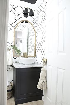 a black and white powder room with text overlay that reads, black and white powder room