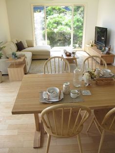 a living room filled with furniture and a flat screen tv sitting on top of a wooden table