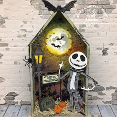 a halloween card with a skeleton holding a jack - o - lantern in front of a house