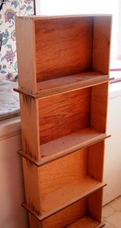 a wooden shelf sitting next to a window