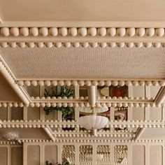 a living room filled with furniture and lots of white balls hanging from the ceiling above