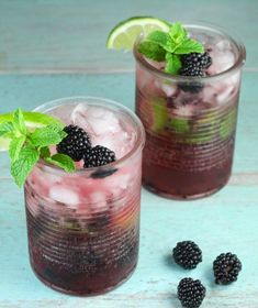 two glasses filled with ice and blackberries