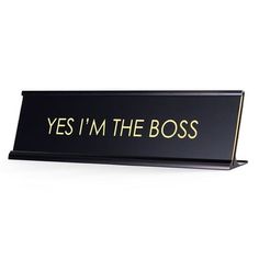 a sign that says, yes i'm the boss on black with gold lettering