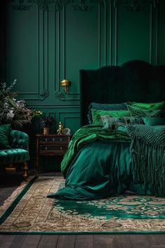 a bed with green sheets and pillows in a dark room next to a couch, chair and table