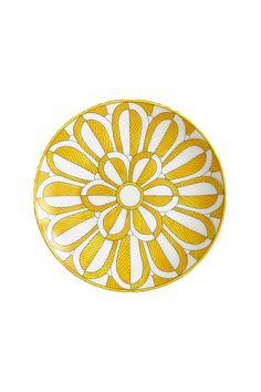 a yellow and white plate with an intricate design on the front, against a white background