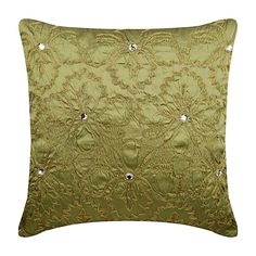 a green pillow with gold threadwork and beads on the front, sitting against a white background