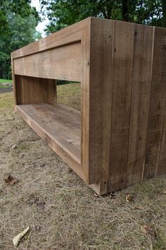 a wooden bench sitting on top of a dry grass field