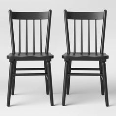 two black wooden chairs side by side