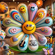 a colorful flower with smiley faces on it in front of many other flowers and decorations