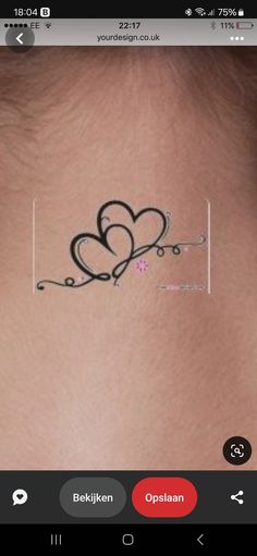 the back of a woman's neck with two hearts drawn on it