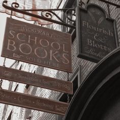 the sign for hogwart's school books is hanging from the side of a building