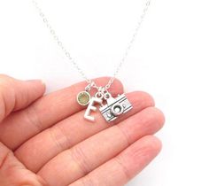 This personalized camera necklace features a silver toned camera charm, silver toned initial charm, and a Swarovski crystal birthstone charm- initial and birthstone of your choice. This necklace is a great gift for photographers!MATERIALS:+ Necklace is composed of silver plated components.+ Camera charm is zinc alloy. + Letter charm is zinc alloy.+ Bead is a Swarovski crystal element birthstone. (Colors may vary slightly from monitor to monitor.)+ January and July birthstones are the same Siam ( Silver Everyday Charm Necklaces With May Birthstone, Silver Charm Necklace With May Birthstone For Everyday, Everyday Silver Charm Necklace With May Birthstone, Necklace Photography, Camera Jewelry, Spiderman Outfit, Camera Charm, Camera Necklace, Photography Jewelry