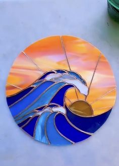 a stained glass sun catcher sitting on top of a table