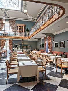 a restaurant with checkered flooring and chandeliers on the ceiling is shown