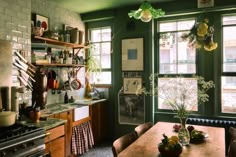 a kitchen filled with lots of counter top space and wooden tables covered in pots and pans