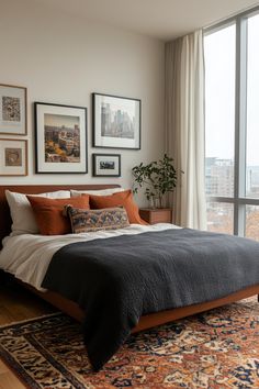 a bedroom with a large bed and pictures on the wall