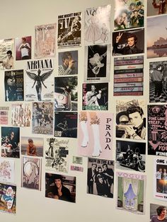 the wall is covered with posters and pictures