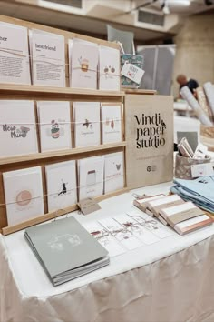 many cards are on the table and there is a sign that says vinti paper studio