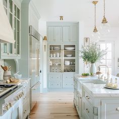 a kitchen filled with lots of white cabinets and counter top space next to an oven