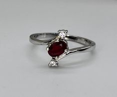 Minimalist Natural Red Ruby Ring 925 Silver Ring Engagement Ring Anniversary Ring Promise Ring Wedding Ring Bridal Ring Multi-stone Ring    ABOUT PRODUCT DETAILS :- Product Code  - NRRR-RGS-02 Main Stone  - Natural Red Ruby  Accent Stone - Moissanite  Stone Quality - AAA  Stone Type - Natural  Stone Color - Red / White  Main Stone  Shape - Oval - Cut  / Round - Cut Stone Size  -  6 X 4  MM  / 1.00 X 1.00 MM About Metal Details - Metal Name - 925 Sterling Silver Metal Purity - 92.5% Metal Polished - Silver Rhodium  Band Width - 1.80 MM ( Approx. ) Total Weight of Product - 1.90 Gram  ( Approx. ) Note - VenusJewelsandArt, is a shop there you can find 925 Silver Jewelry. Our first target is satisfaction of our buyers. We will always aware of our buyers and we are here for their help. For any Etsy Engagement Rings, Natural Ruby Ring, Ruby Engagement Ring, Sterling Silver Engagement Rings, Silver Engagement Rings, Art Deco Ring, Ruby Ring, Three Stone Rings, Rings For Her