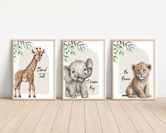 three framed pictures with animals on them in front of a white wall and wooden floor