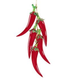 three red peppers hanging from a string