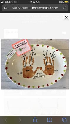 a plate with handprints on it that says merry christmas and is being displayed