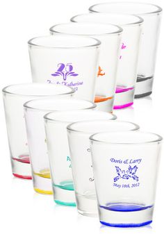 six shot glasses with different colored liquids in the bottom and bottom, all lined up