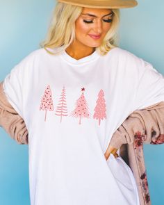 🎄 Pretty in Pink for the Holidays! 🌸 Elevate your Christmas style with our charming Pink Christmas Tree shirt. Perfect for adding a pop of festive elegance to your holiday wardrobe. ✨ Available now to make your season merry and bright. 💖👕 Cute Long Sleeve T-shirt For Holiday, White Winter Holiday T-shirt, Cute White Christmas Tops, White Winter Tops As Gift, White Winter Tops As Gifts, White Winter Tops For Gifts, White Winter Tops As A Gift, Cute White Top For Festive Occasions, White Long Sleeve T-shirt For Holiday