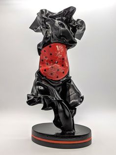 a black and red sculpture on a white background