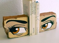 two bookends made to look like eyes with brown and black eyelashes on them