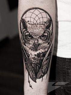 an owl tattoo on the arm with a dream catcher in it's centerpiece