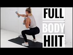 a woman doing a full body workout with dumbbells in front of a white wall