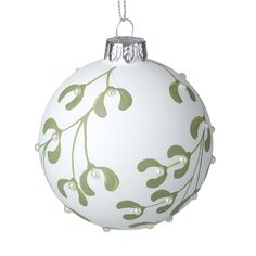 a white ornament with green leaves on it