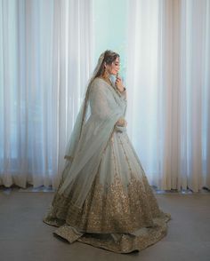 a woman in a white and gold bridal gown