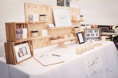 a table topped with wooden shelves filled with candles