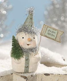 a snowman with a christmas tree on his head holding a sign that says merry