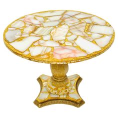 a gold and white table with marble top