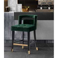 a green velvet bar stool in front of a kitchen counter with potted plants on it