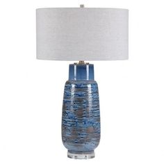 a blue table lamp with a white shade