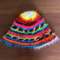 a multicolored hat sitting on top of a wooden table